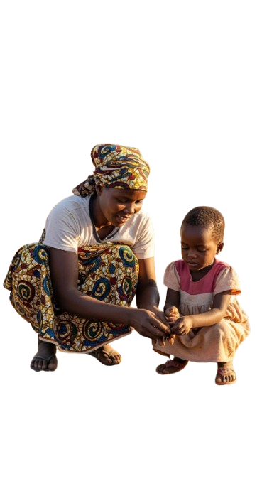 A Children's Mama kneeling beside a young child in a Care Village, holding his hand